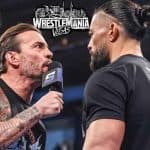 CM Punk talking on the microphone to Roman Reigns with a WrestleMania Vegas logo above